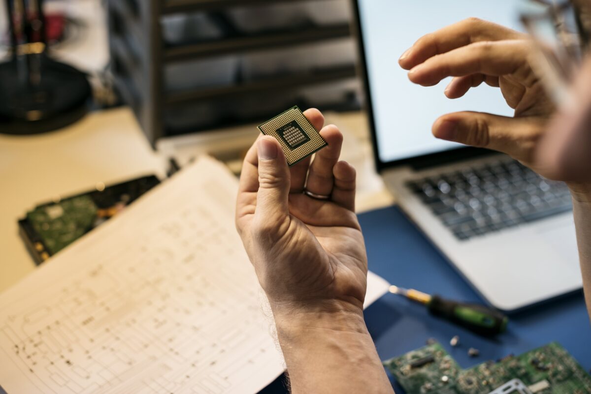 Engineer using PCB calculator on laptop for circuit design analysis